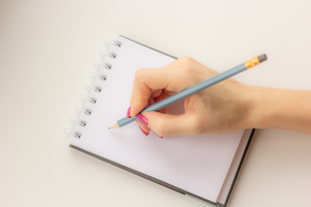 Women’s hand writing in journal